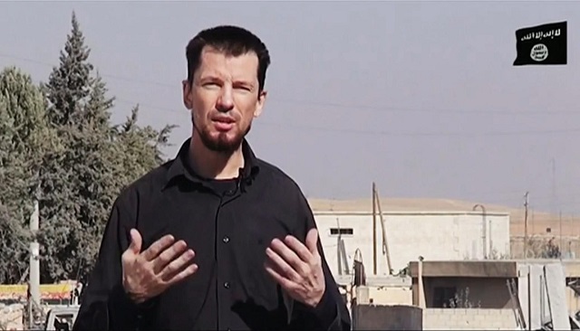 Na nedatovanej snímke z videa zverejenej 28. októbra 2014 britský rukojemník John Cantlie, zadriavaný militantmi organizácie Islamský štát