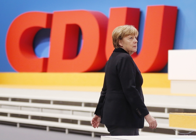 Na snímke šéfka Kresťanskodemokratickej únie (CDU) a nemecká kancelárka Angela Merkelová kráča okolo loga strany na spolkovom zjazde CDU v Karlsruhe